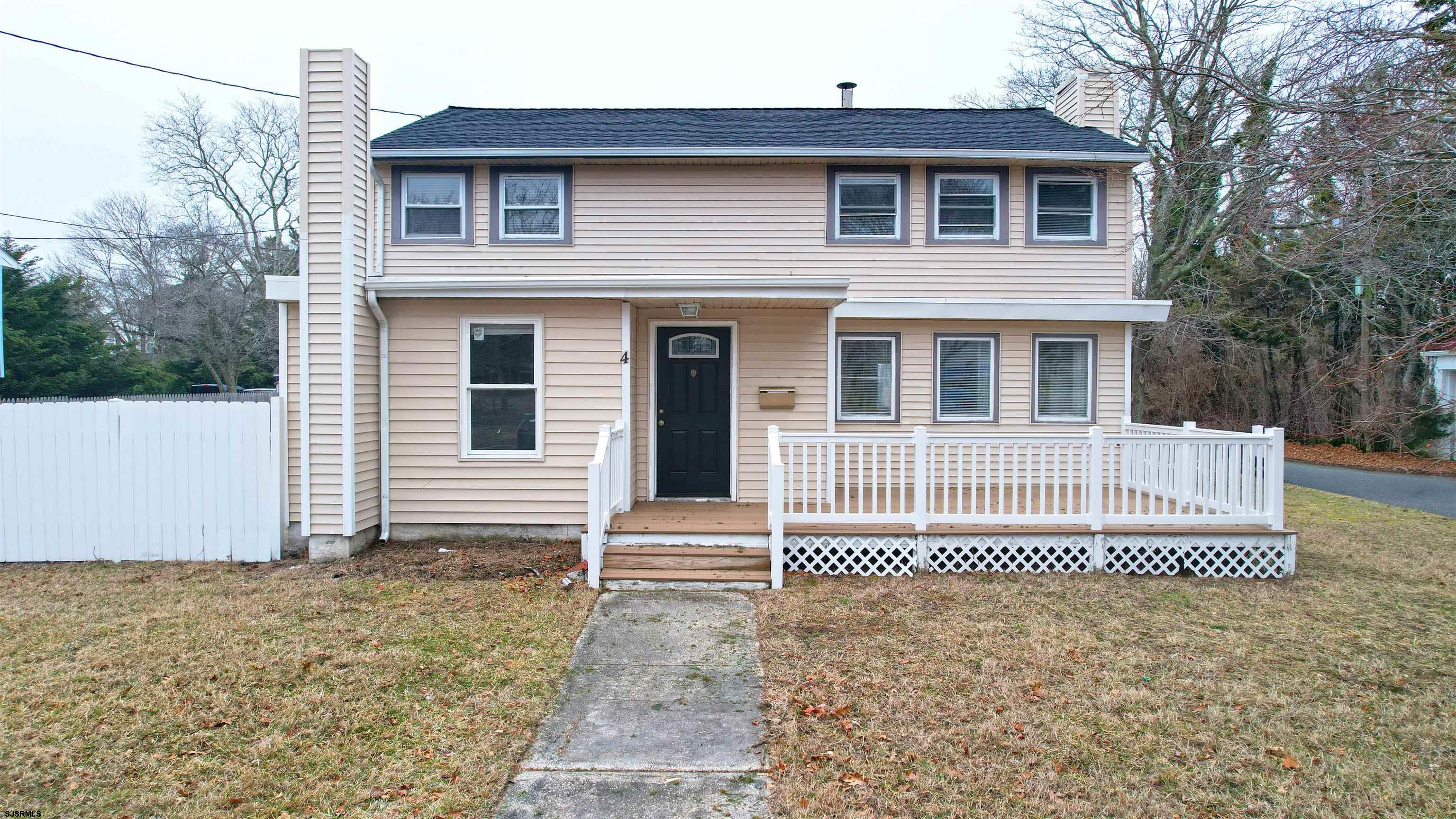 a front view of a house with a fence