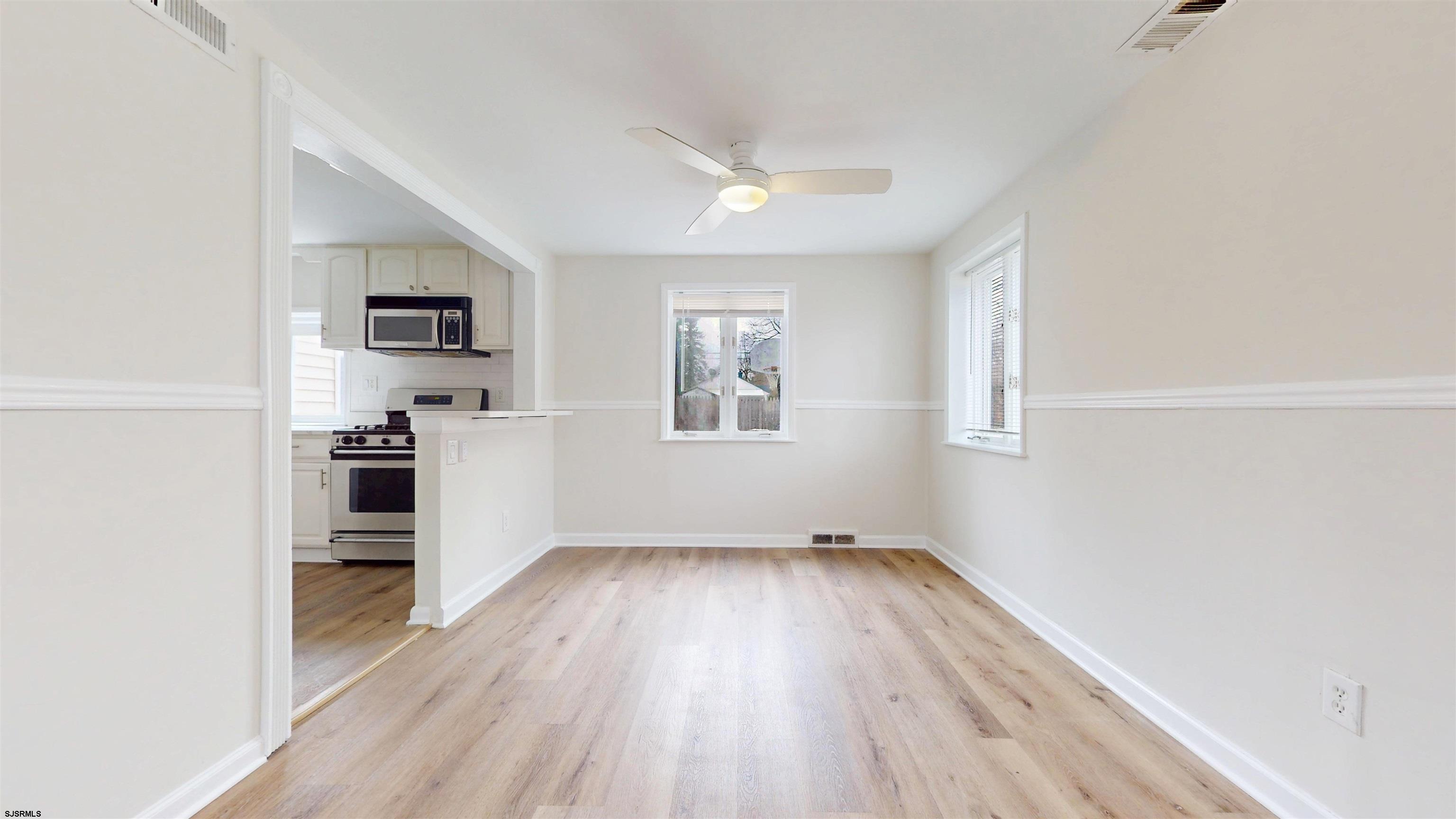 4 East Mill Road Northfield, NJ 08225 - Photo 11 of 49 an empty room with wooden floor and windows