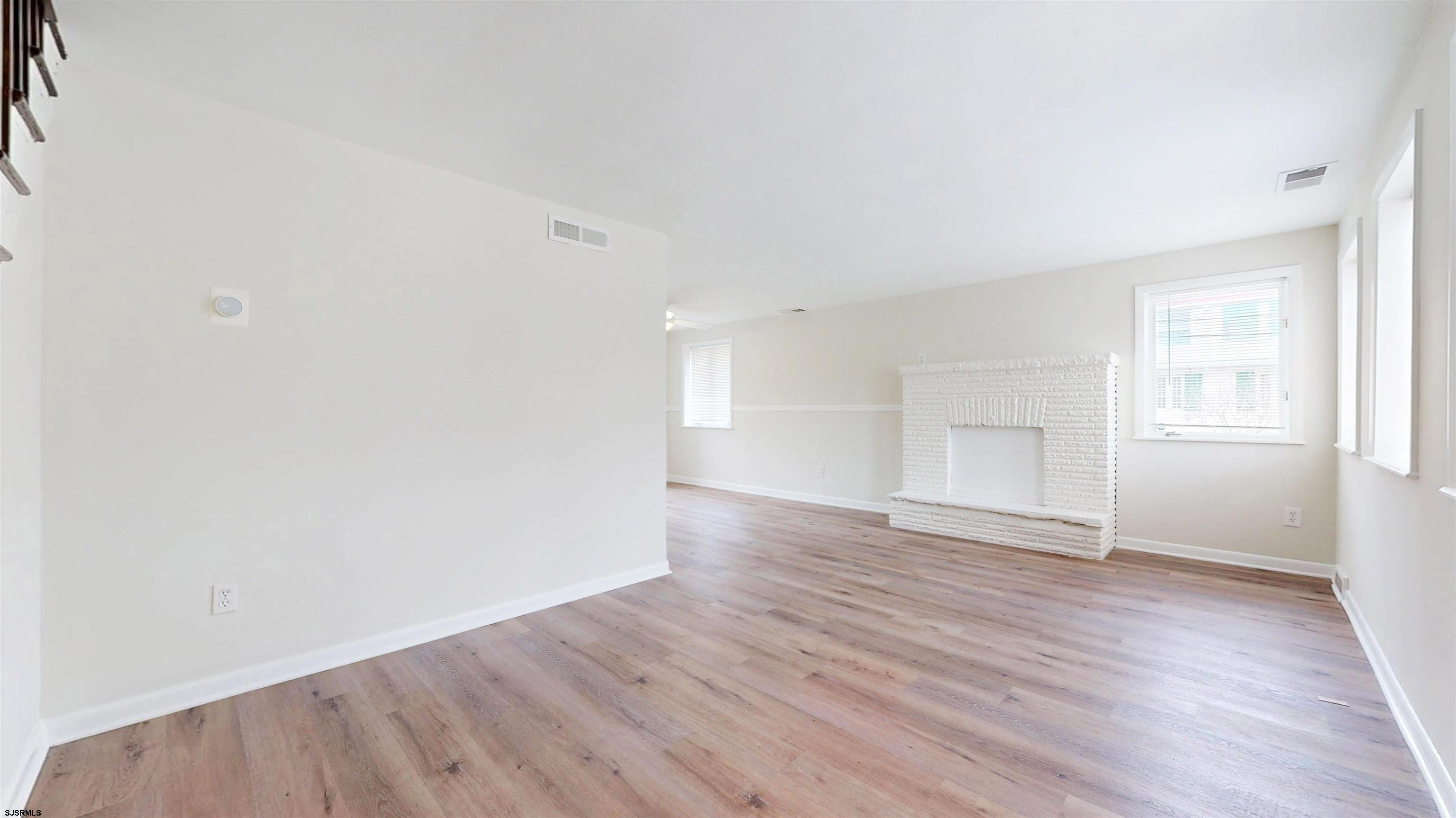 4 East Mill Road Northfield, NJ 08225 - Photo 13 of 49 an empty room with wooden floor and windows