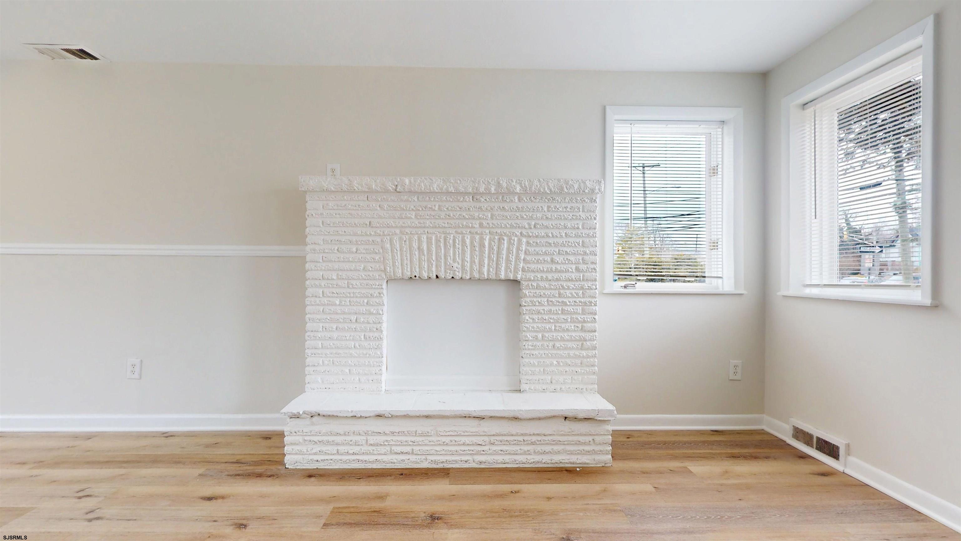 4 East Mill Road Northfield, NJ 08225 - Photo 14 of 49 a view of a livingroom with wooden floor and a window