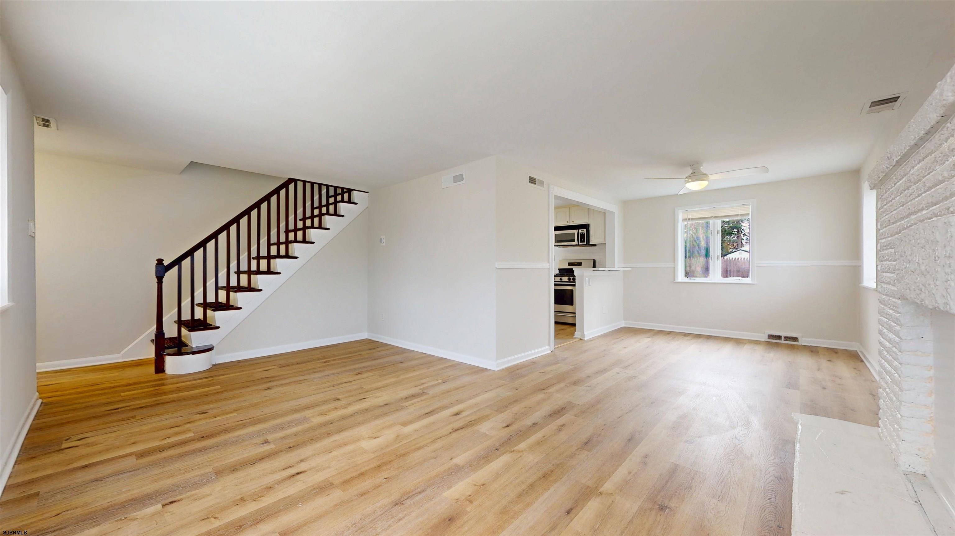 4 East Mill Road Northfield, NJ 08225 - Photo 15 of 49 a view of an empty room with wooden floor and a window