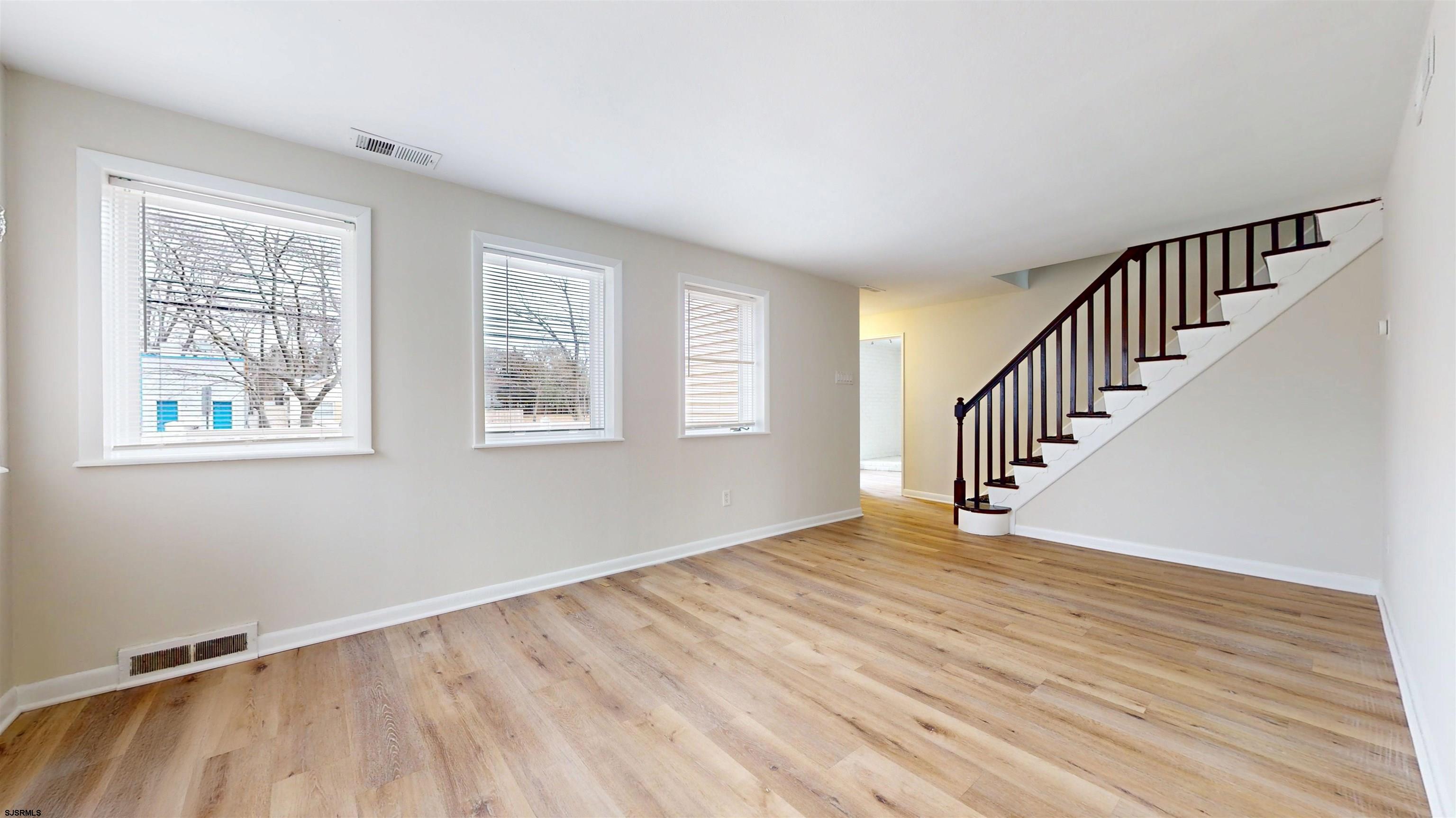 4 East Mill Road Northfield, NJ 08225 - Photo 16 of 49 a view of an empty room with wooden floor and a window