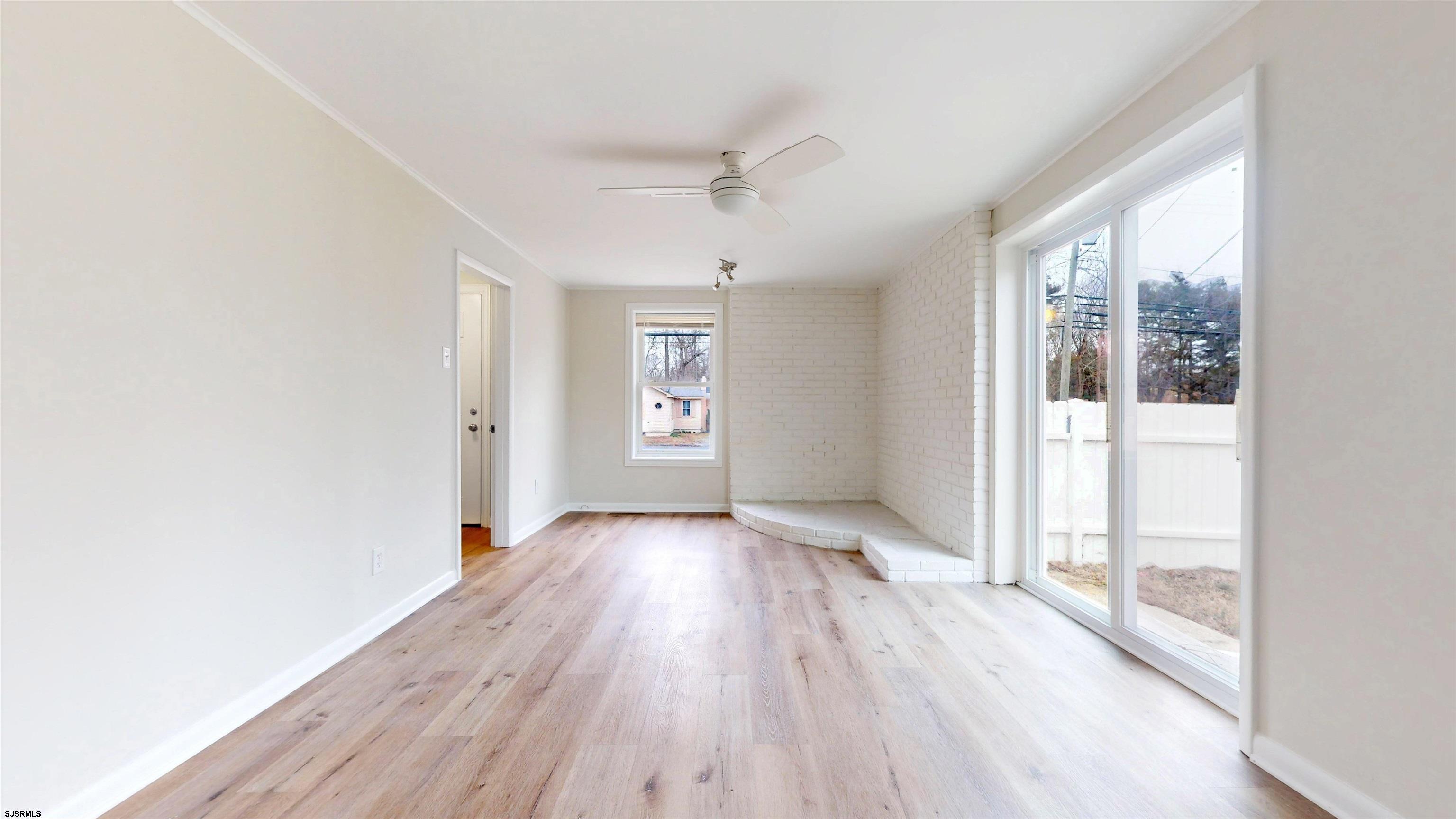 4 East Mill Road Northfield, NJ 08225 - Photo 17 of 49 an empty room with wooden floor and windows