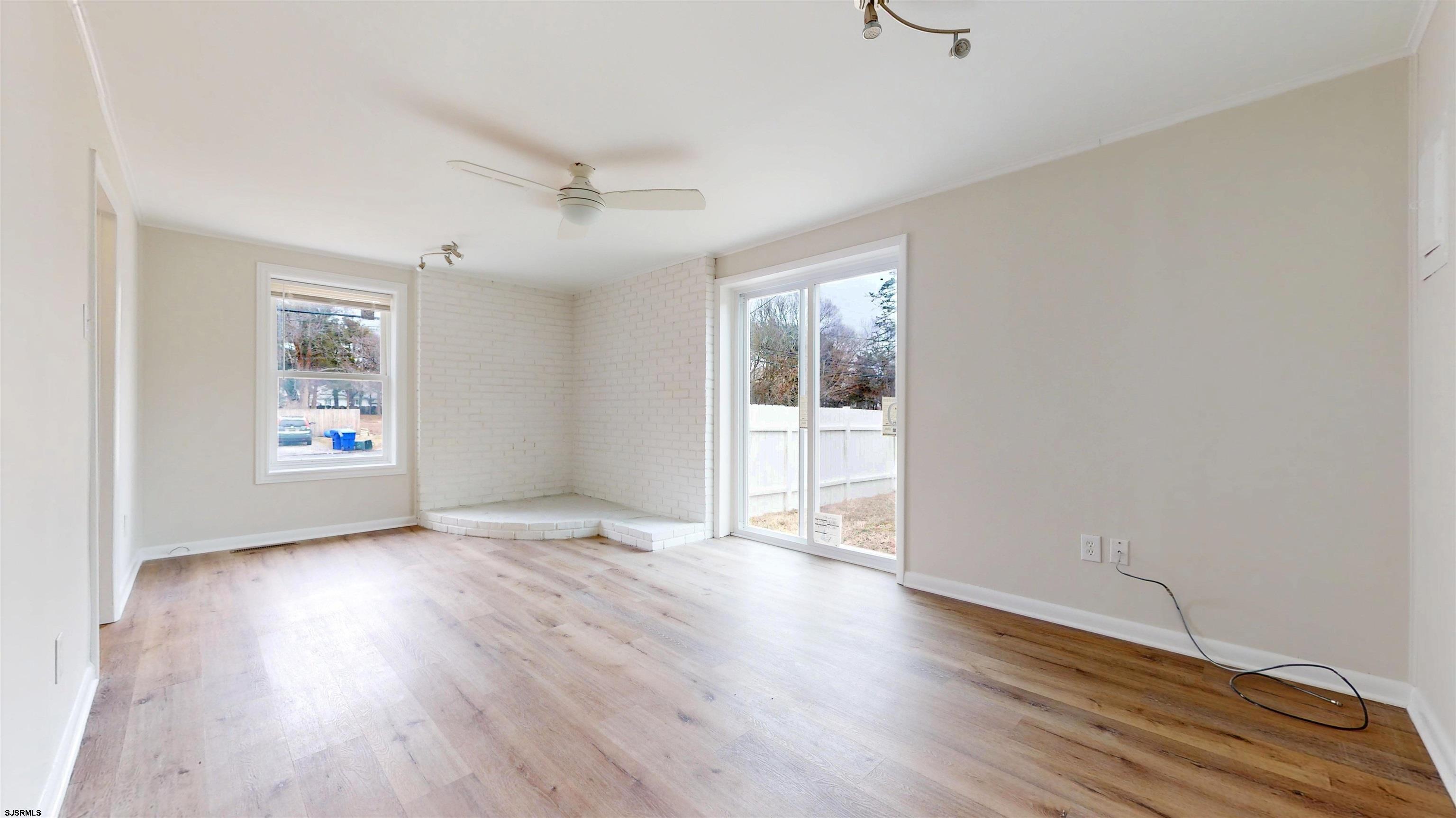 4 East Mill Road Northfield, NJ 08225 - Photo 18 of 49 an empty room with wooden floor and windows