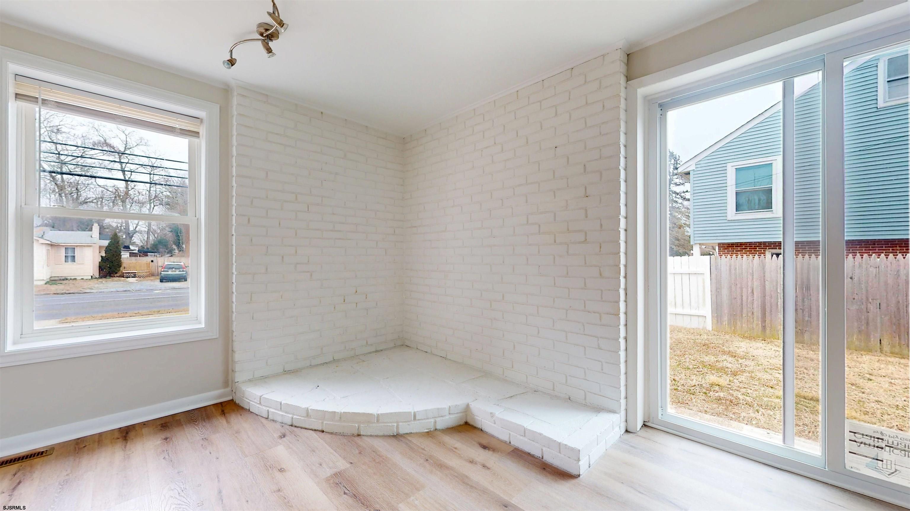 4 East Mill Road Northfield, NJ 08225 - Photo 19 of 49 an empty room with wooden floor and windows