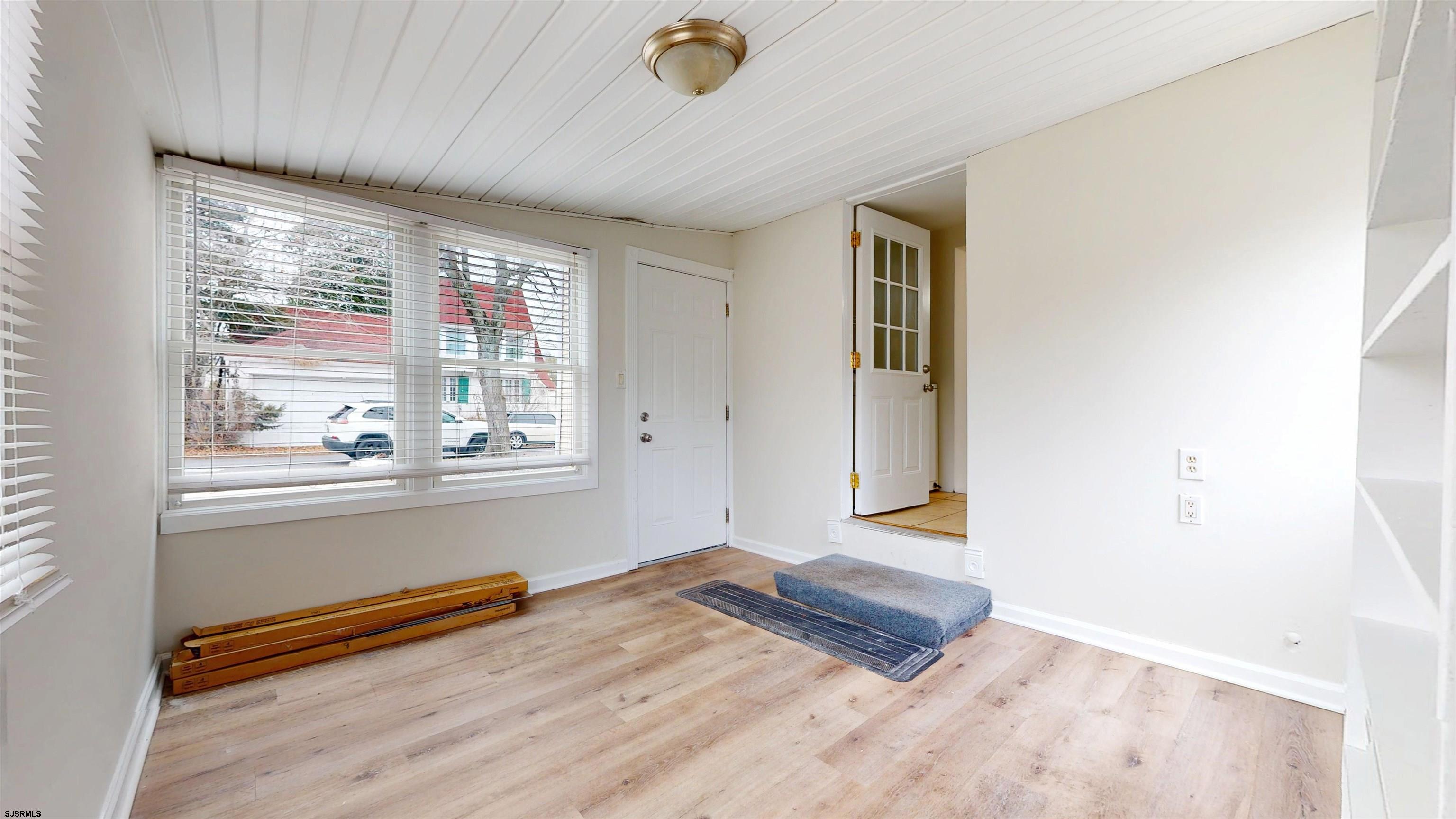 4 East Mill Road Northfield, NJ 08225 - Photo 21 of 49 a view of an empty room with a window and wooden floor