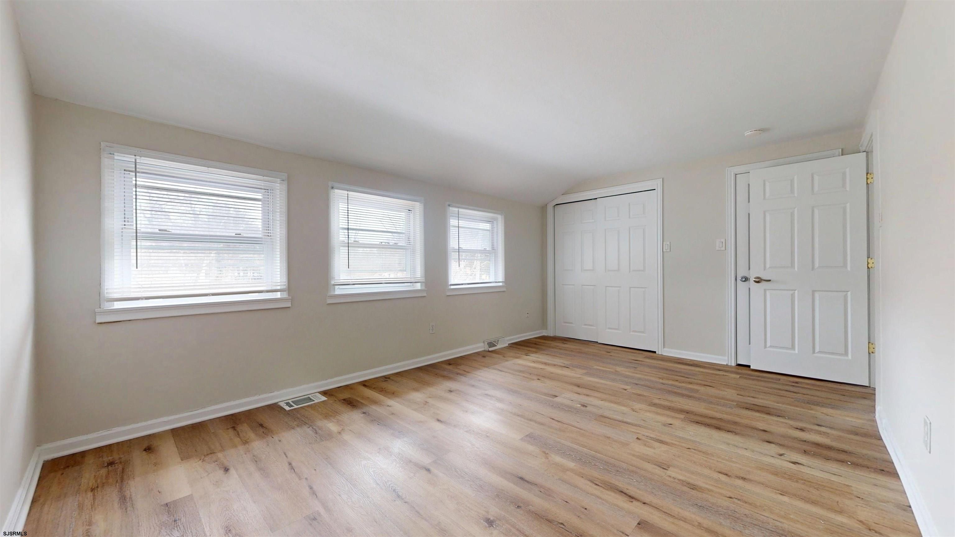 4 East Mill Road Northfield, NJ 08225 - Photo 26 of 49 a view of an empty room with wooden floor and a window