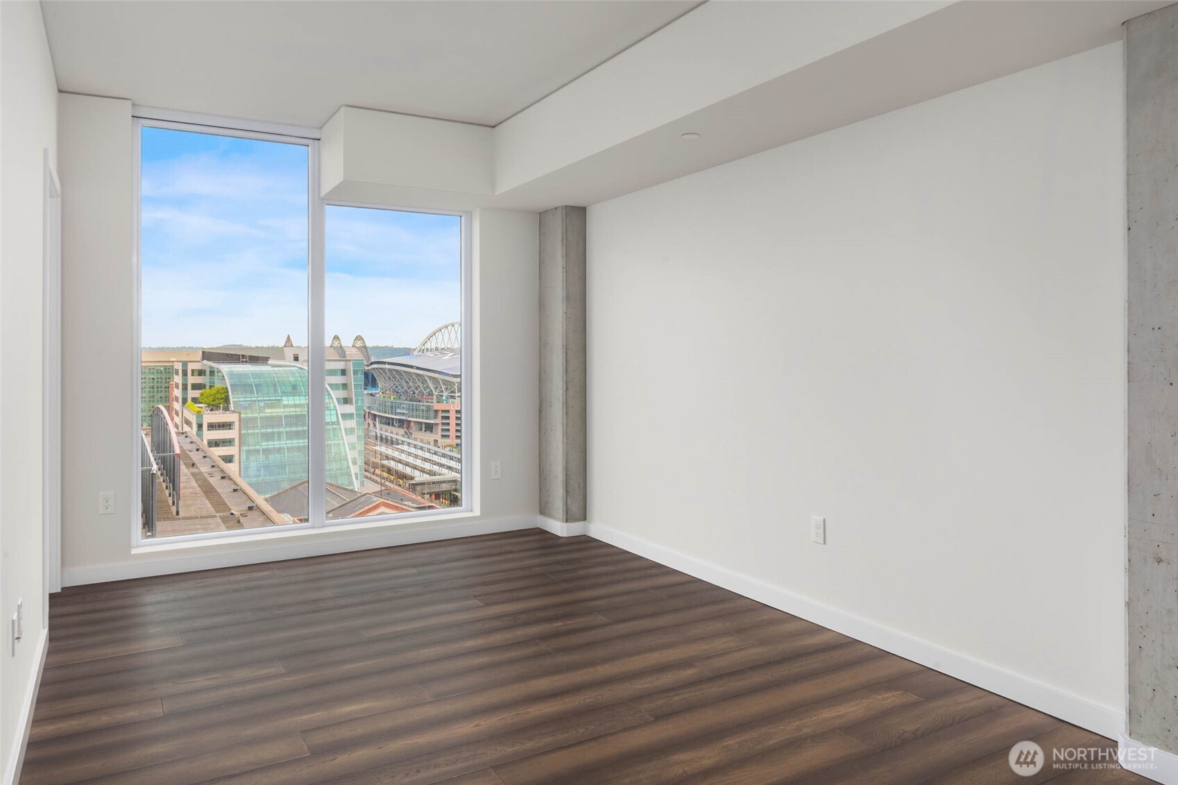 450 South Main Street, Unit 1405 Seattle, WA 98104 - Photo 11 of 38 a view of an empty room with wooden floor and a window