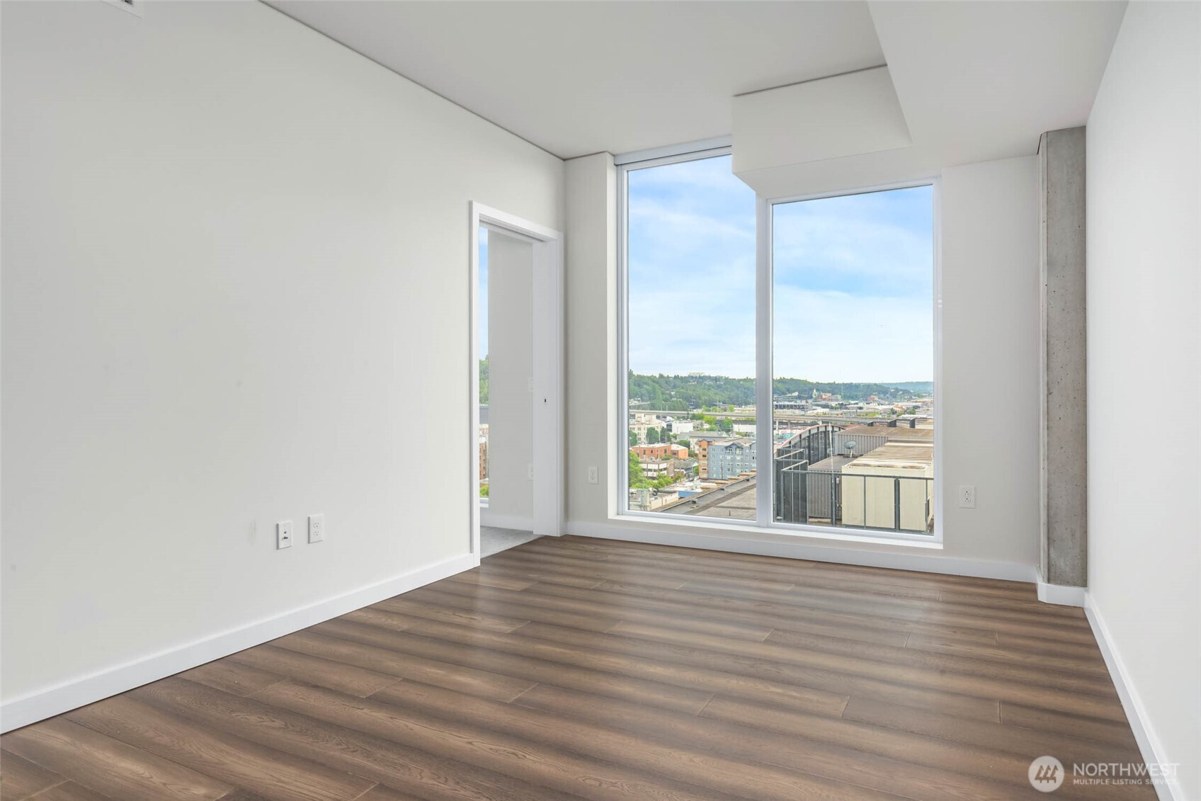 450 South Main Street, Unit 1405 Seattle, WA 98104 - Photo 13 of 38 a view of an empty room with wooden floor and a window