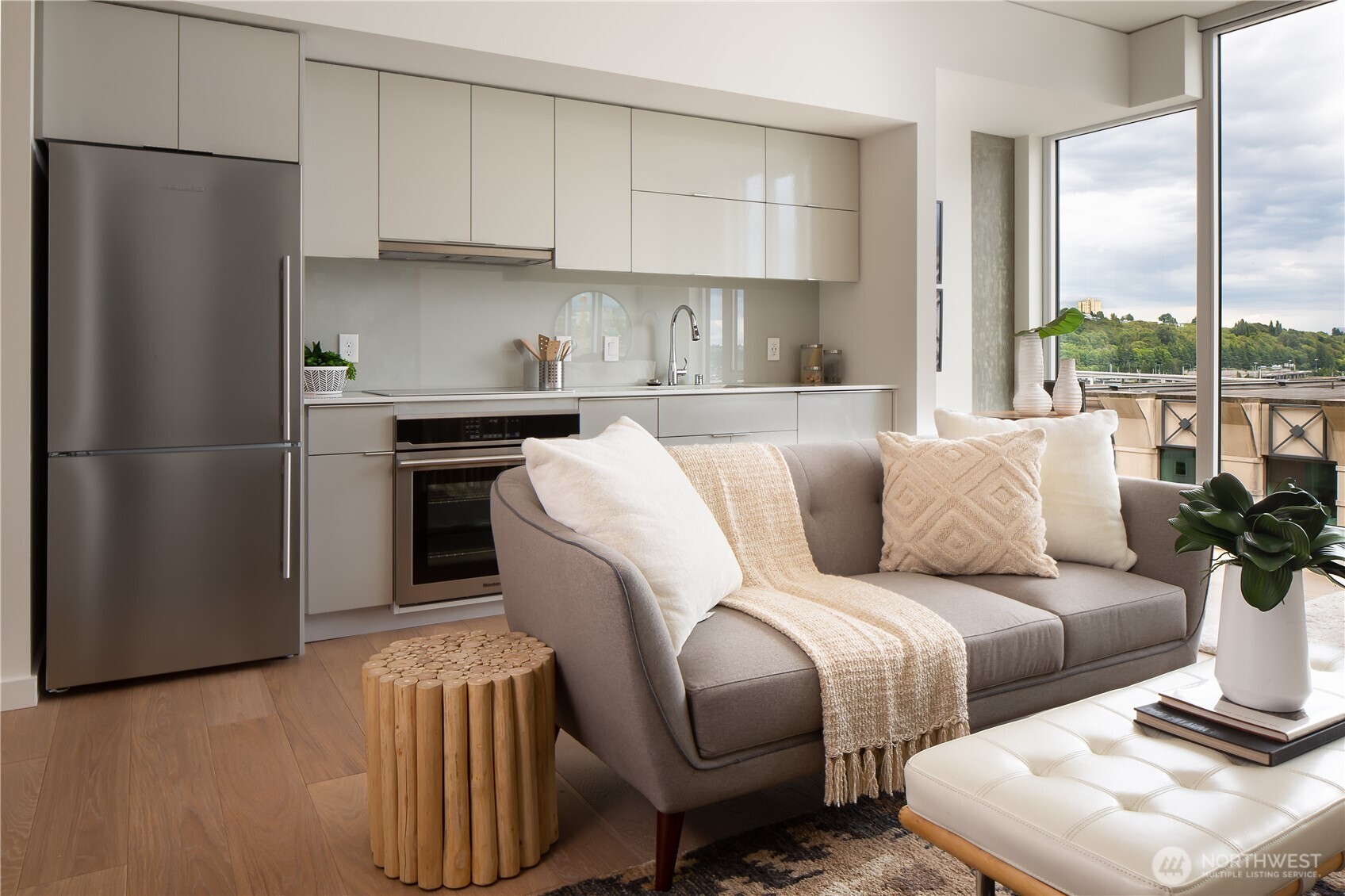 450 South Main Street, Unit 1405 Seattle, WA 98104 - Photo 2 of 38 a living room with furniture a large window and a refrigerator