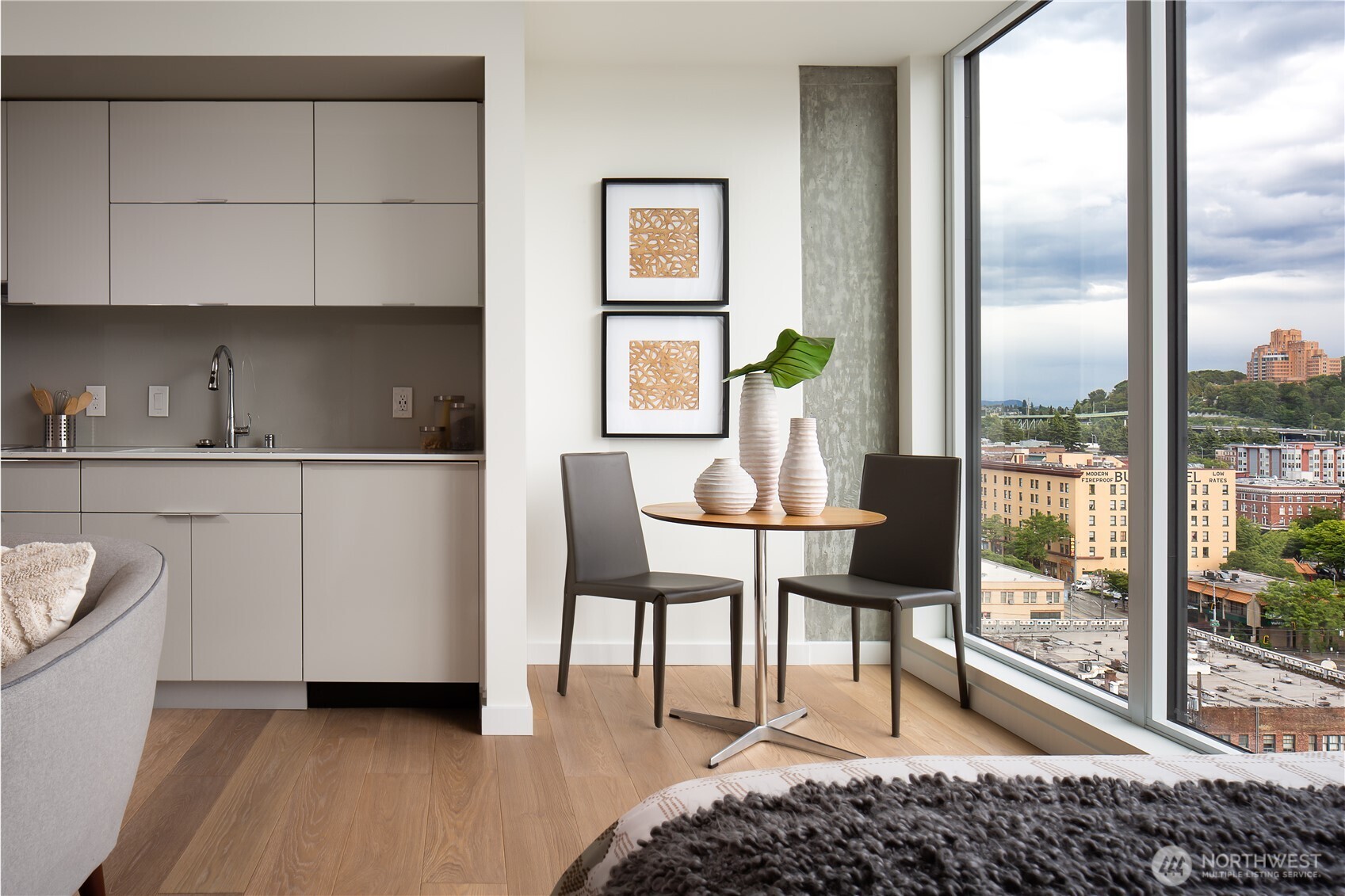 450 South Main Street, Unit 1405 Seattle, WA 98104 - Photo 3 of 38 a living room with furniture a window and a painting on the wall