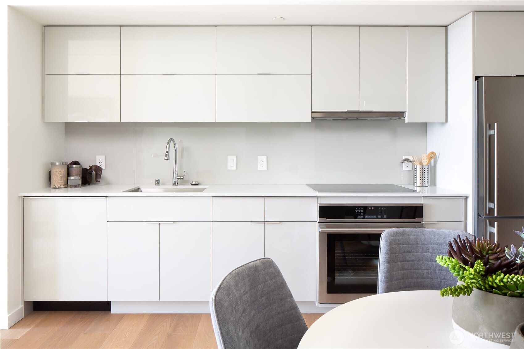 450 South Main Street, Unit 1405 Seattle, WA 98104 - Photo 5 of 38 a kitchen with stainless steel appliances a stove a sink and a refrigerator