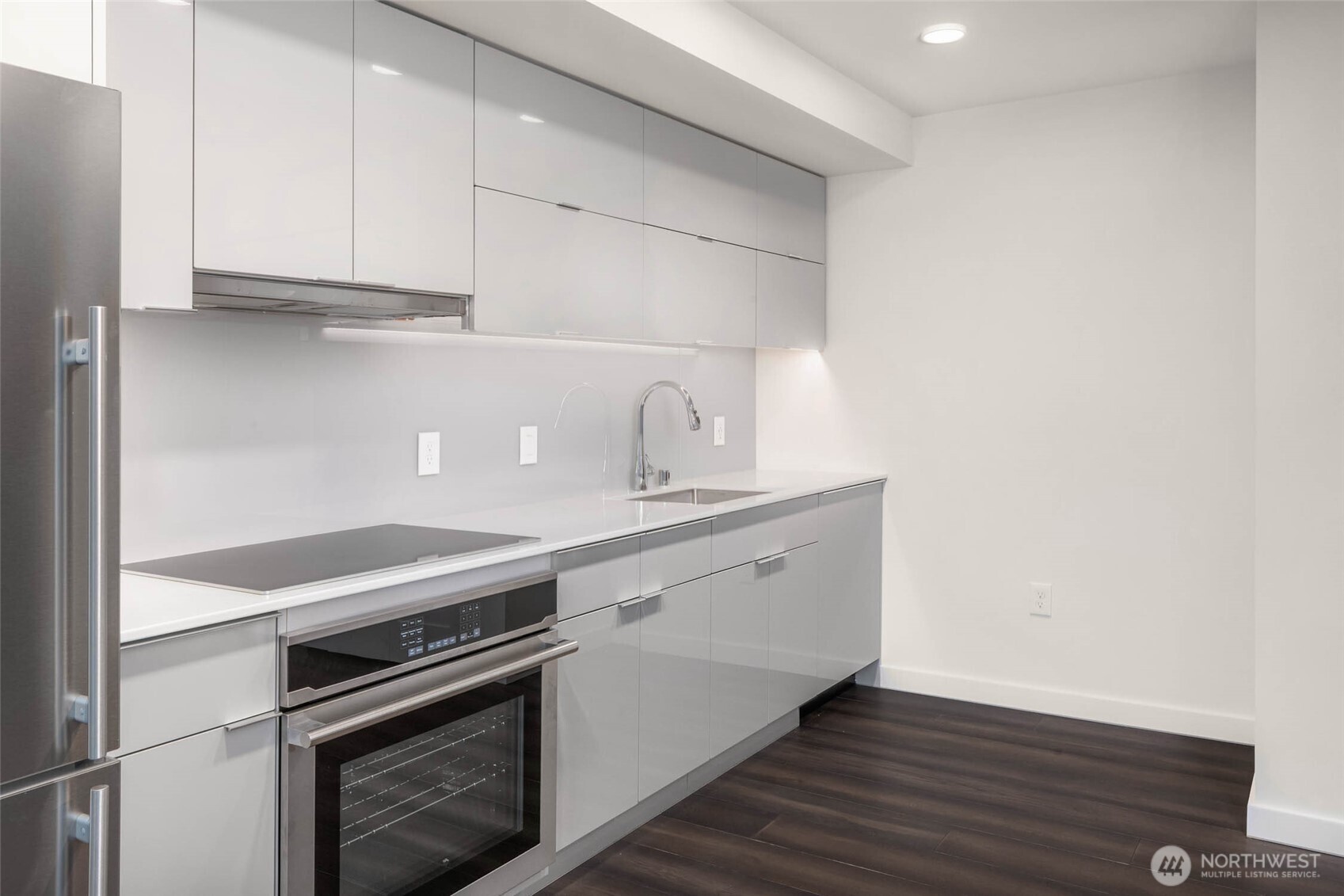 450 South Main Street, Unit 1405 Seattle, WA 98104 - Photo 10 of 38 a kitchen with granite countertop a stove and a sink