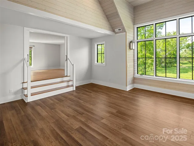 a view of a lush green outdoor space with a lake view