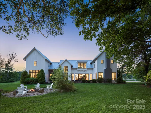 a front view of a house with a garden and plants