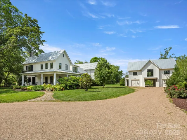 a front view of a house with a yard and outdoor seating