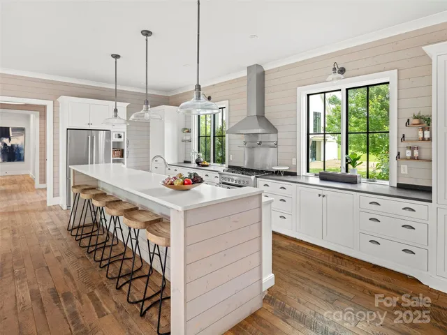 a view of a kitchen with kitchen island a large island in the center