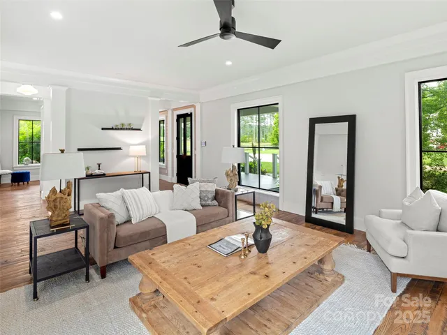 a view of entryway with wooden floor and windows