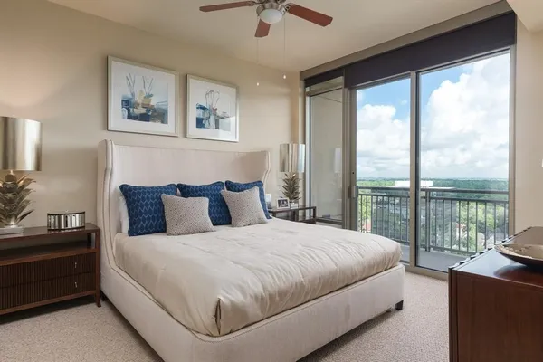 a bedroom with a large bed and a balcony view