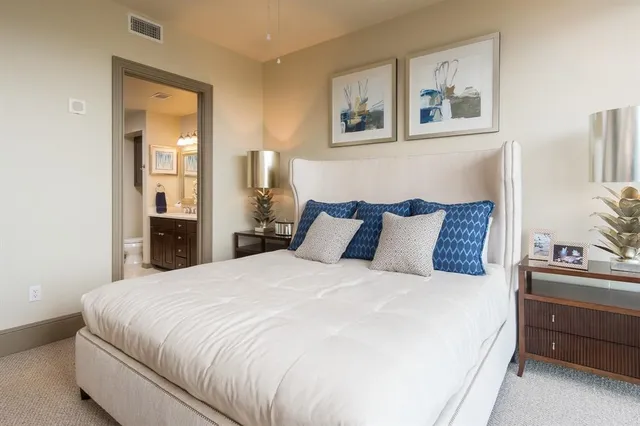 a large white bed in a white room