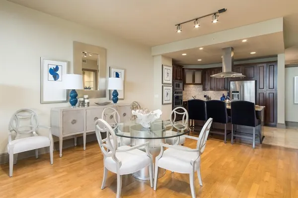 a dining room with furniture and a wooden floor