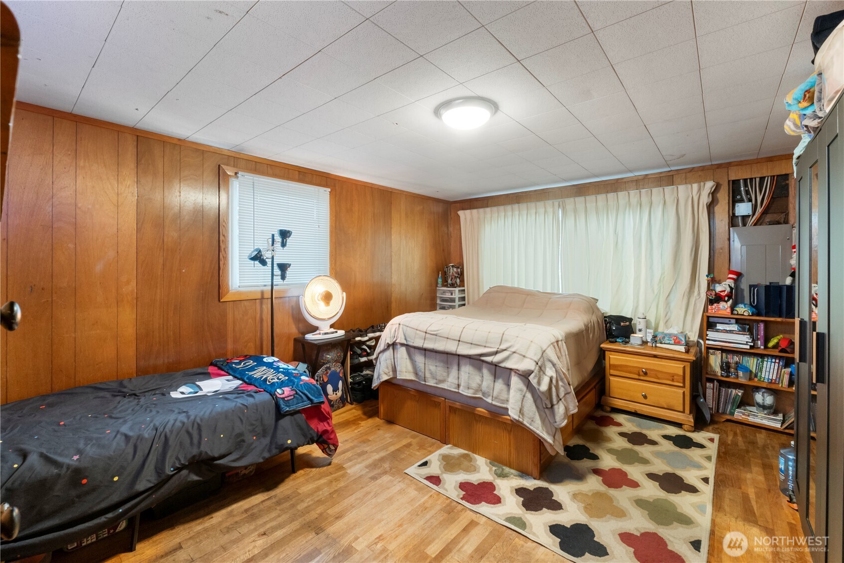 1411 Ruddell Road Southeast Lacey, WA 98503 - Photo 17 of 40 a bedroom with a bed and wooden floor