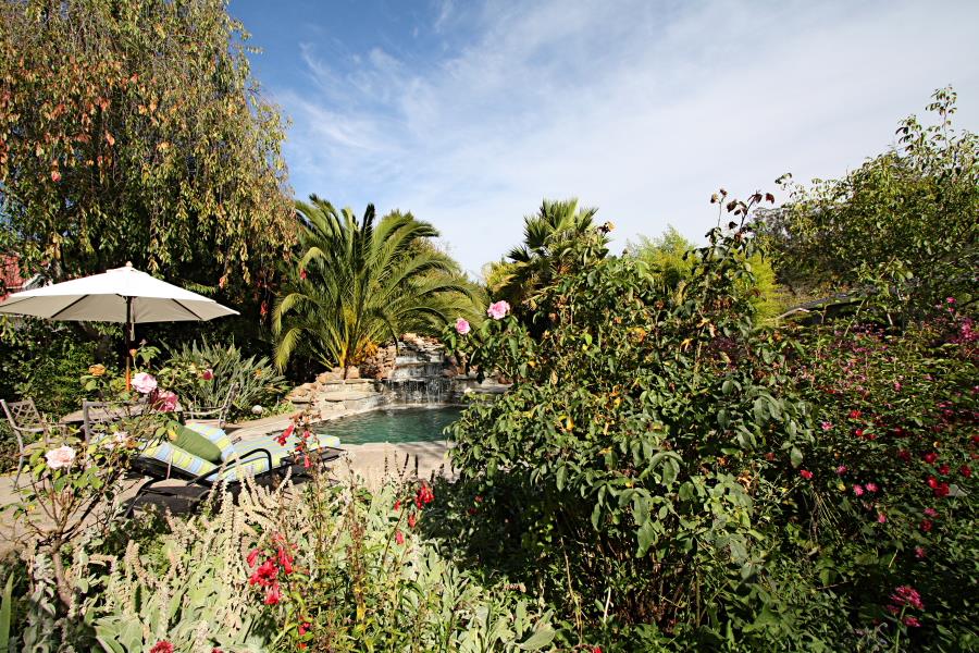 3999 Cherryvale Avenue Soquel, CA 95073 - Photo 14 of 23 a backyard of a house with table and chairs under an umbrella