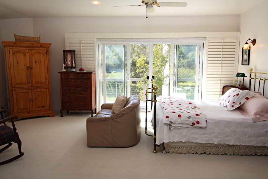 3999 Cherryvale Avenue Soquel, CA 95073 - Photo 17 of 23 a bedroom with furniture and large windows