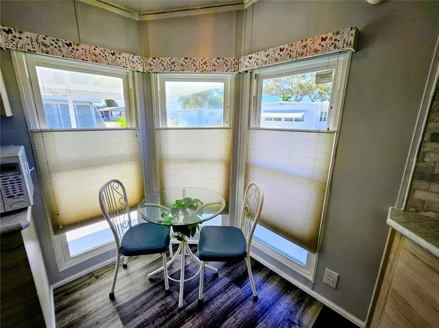 a bed sitting in a bedroom next to a lamp
