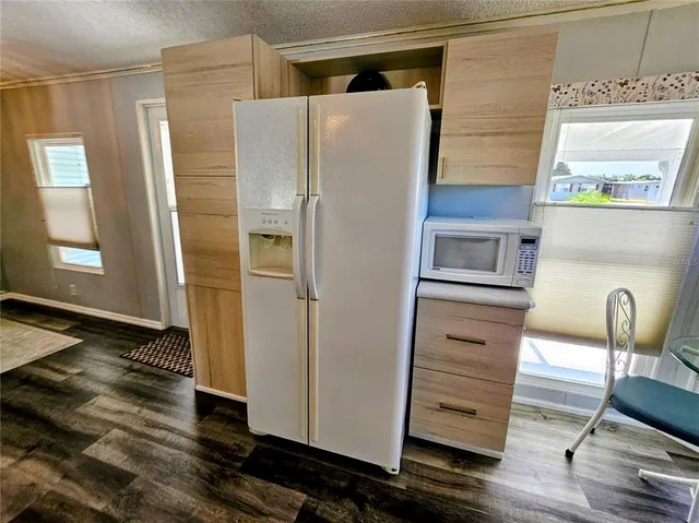 a bathroom with a glass door shower and vanity