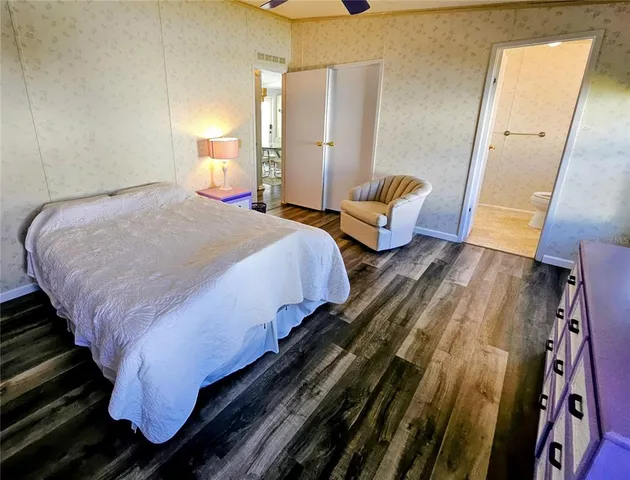 a bathroom with a granite countertop sink mirror vanity and toilet