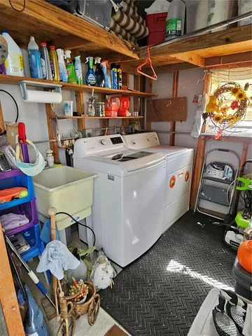 a view of a patio with a table and chairs under an umbrella