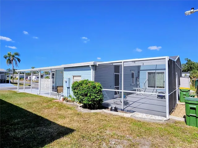 a view of a patio with table and chairs potted plants and palm tree