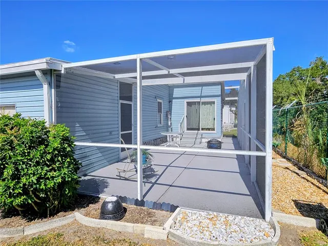 a view of a house with a yard patio and swimming pool