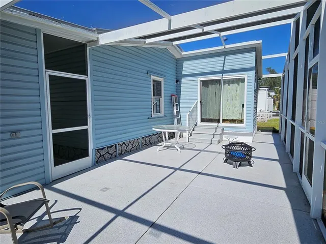 a living room with furniture a rug and a window