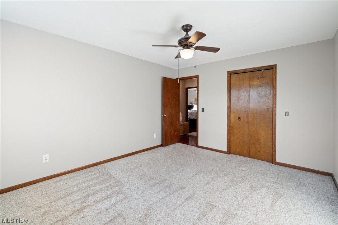 8221 Stone Road Medina, OH 44256 - Photo 19 of 35 Unfurnished bedroom with ceiling fan, a large closet, and light carpet
