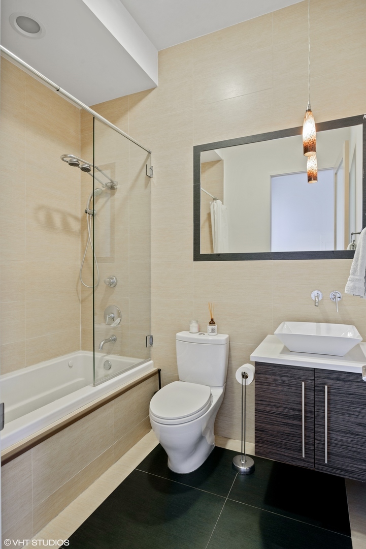 2408 West Rice Street, Unit 203 Chicago, IL 60622 - Photo 12 of 17 a bathroom with a sink toilet and shower
