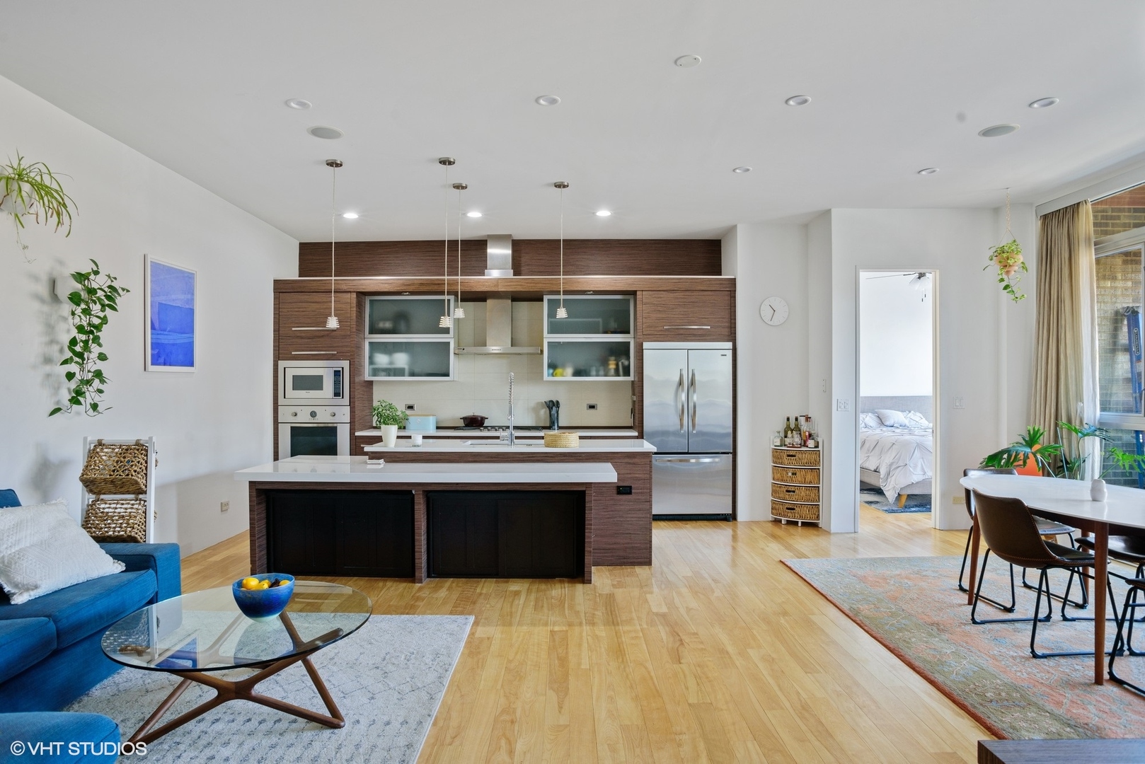 2408 West Rice Street, Unit 203 Chicago, IL 60622 - Photo 2 of 17 a living room with stainless steel appliances furniture a rug and a table