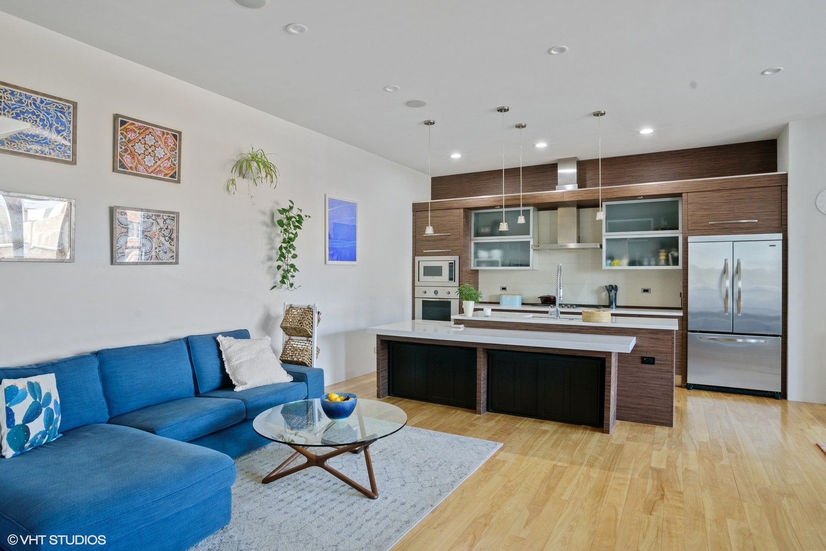 2408 West Rice Street, Unit 203 Chicago, IL 60622 - Photo 3 of 17 a living room with stainless steel appliances furniture a rug and a kitchen view