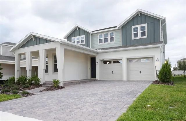 a front view of a house with a garden and garage