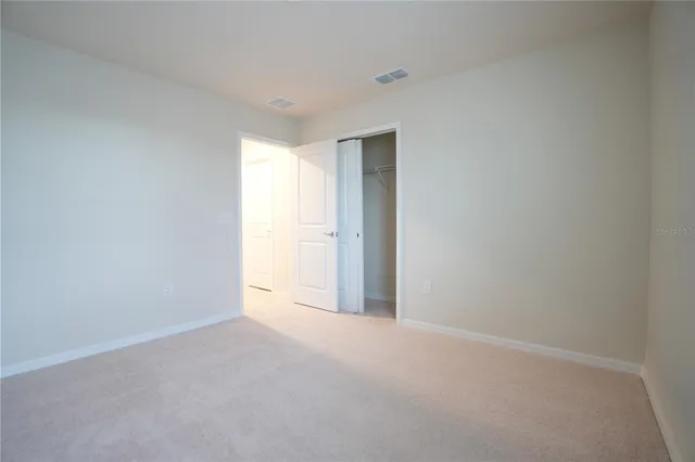 a view of an empty room and a window