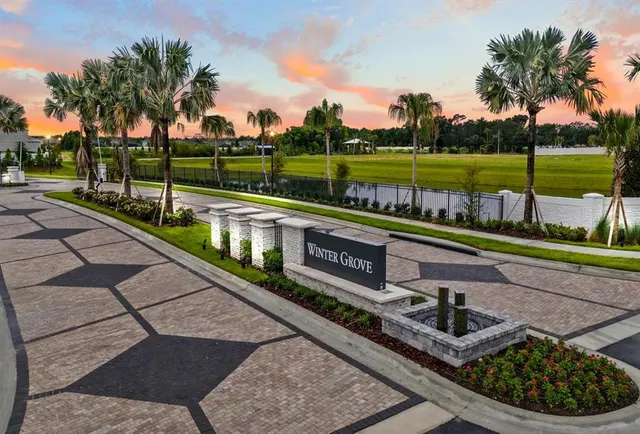 a view of a swimming pool with a garden and trees