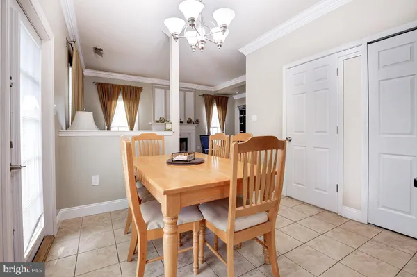 a view of a dining room with furniture and a chandelier