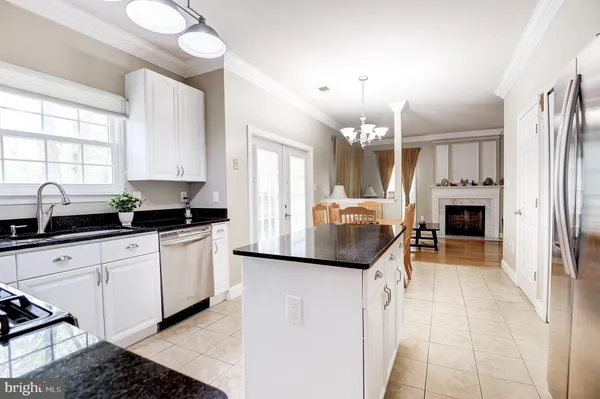 a kitchen with refrigerator and cabinets