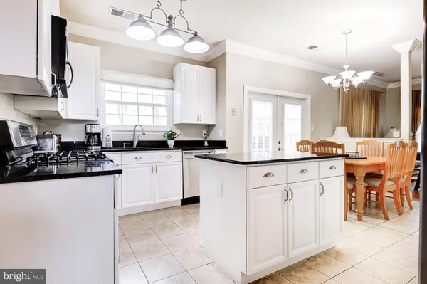 a kitchen with cabinets a sink and appliances