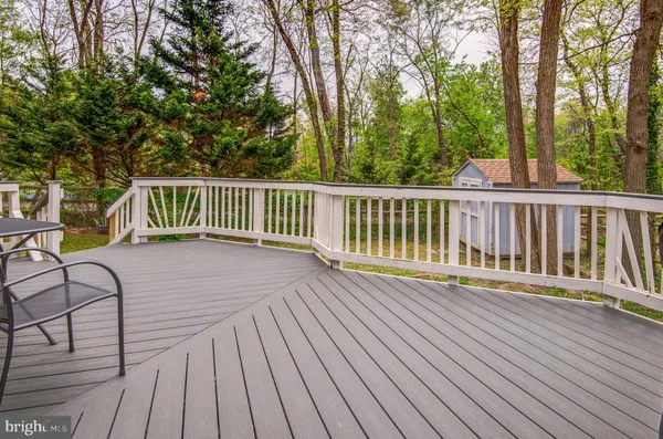 a view of balcony with wooden floor and fence