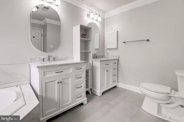 a spacious bathroom with a toilet sink and mirror