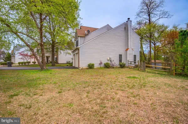 a view of a house with garden and trees