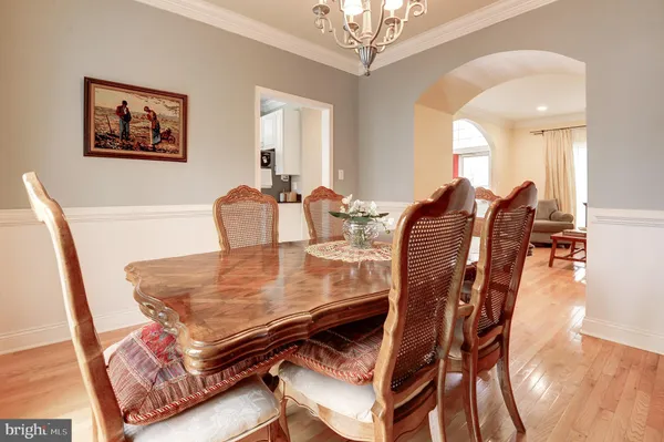 a dining room with furniture and chandelier