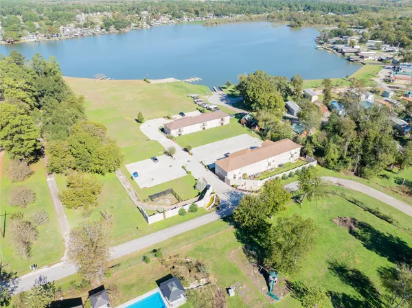 an aerial view of lake and residential houses with outdoor space